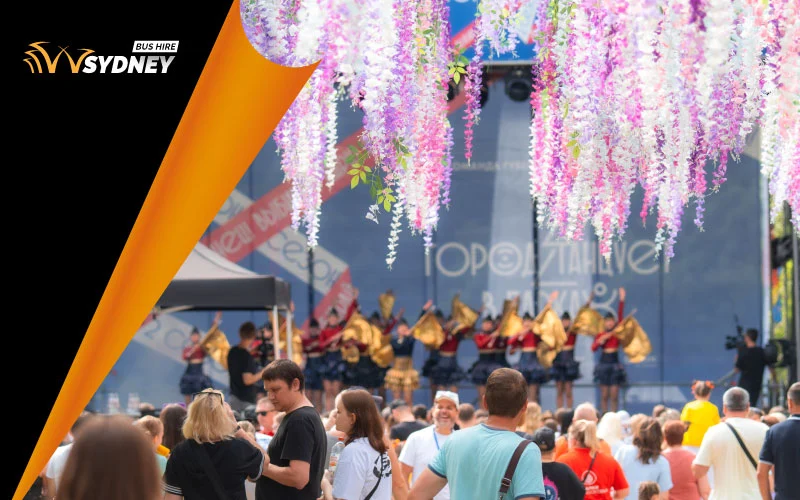 Festival crowd enjoying immersive theatre at Sydney Fringe with lanterns and pop-up stage in The Rocks Sydney coach hire with driver
